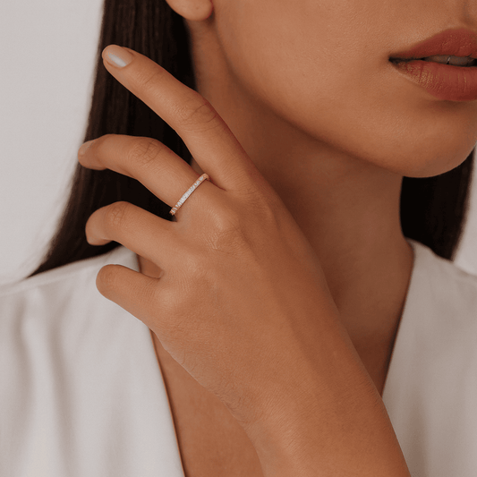 Close-up of a hand wearing a gold plated ring