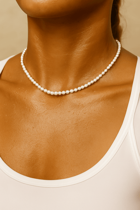 Pearl sweat resistant necklace worn by a woman with a neutral background