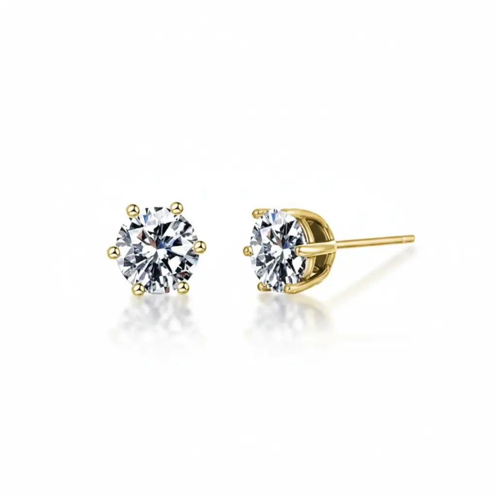 Pair of gold zirconia stud earrings on a white background
