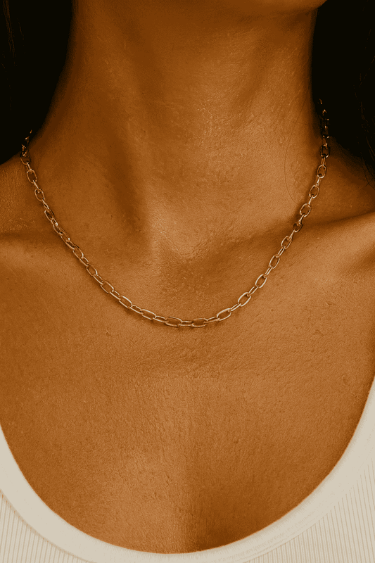 Close-up of a woman wearing a gold-plated chain necklace 