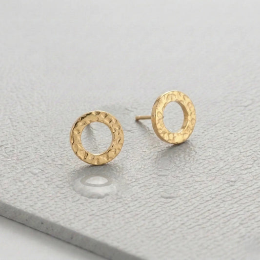 Waterproof gold circle earrings on a light gray fitness mat.