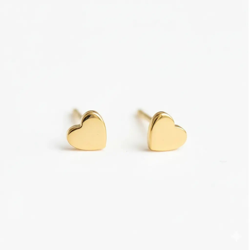 Waterproof heart gold studs earrings on a white background