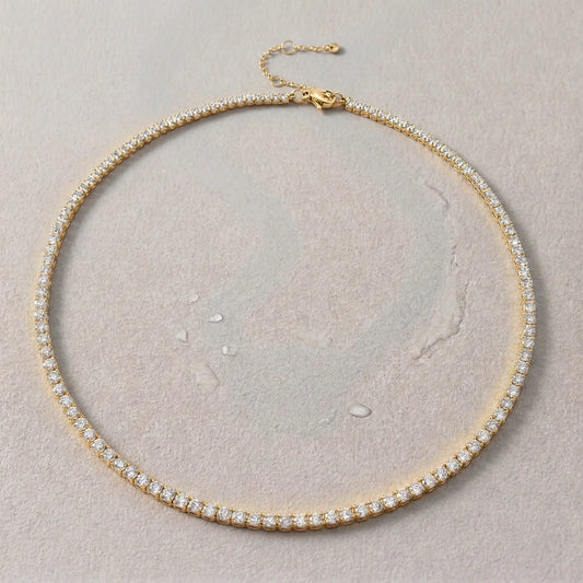 Gold sweat-resistant necklace with diamonds on a light gray background.
