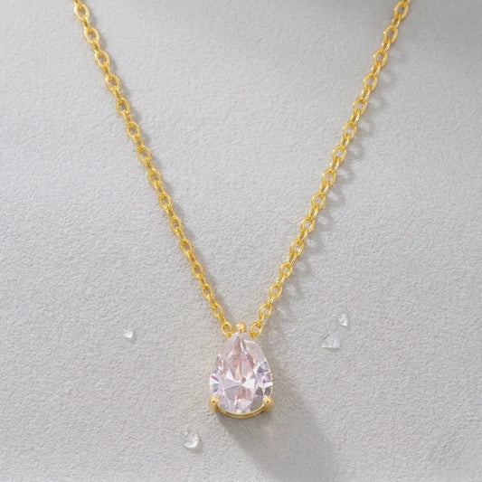 Waterproof gold-plated necklace with a zirconia pendant on a light gray background.