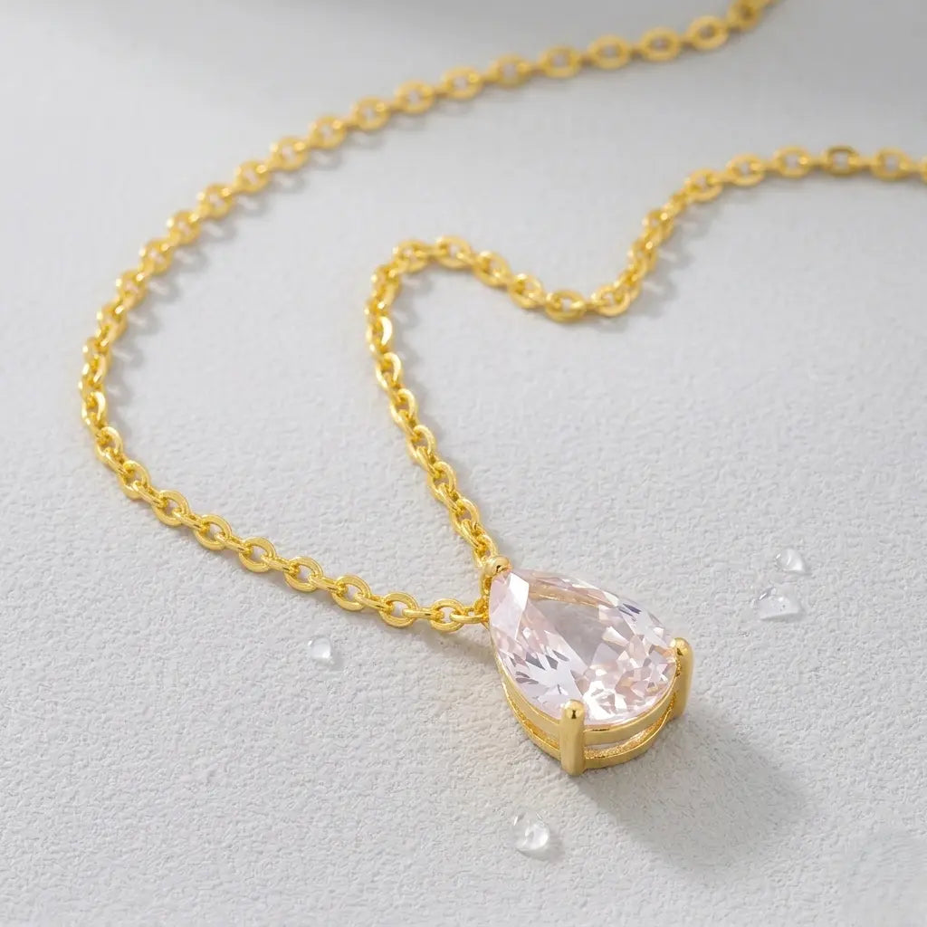 Gold-plated necklace with a zirconia pendant on a light gray background.
