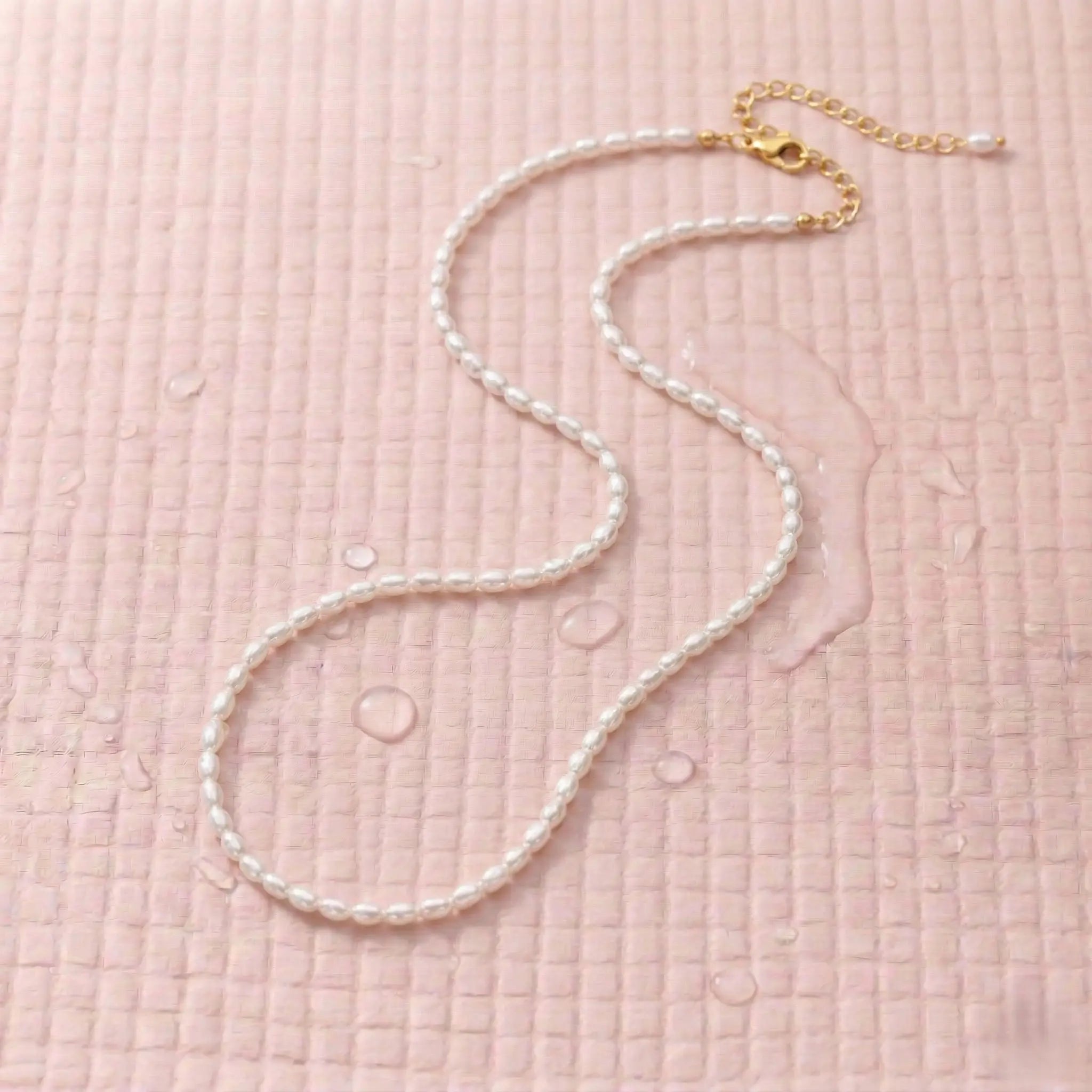 Waterproof pearl necklace on a pink fitness mat.