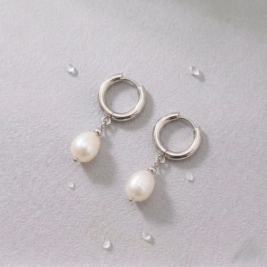 Silver-plated waterproof hoop earrings with pearl drops on a light gray background.