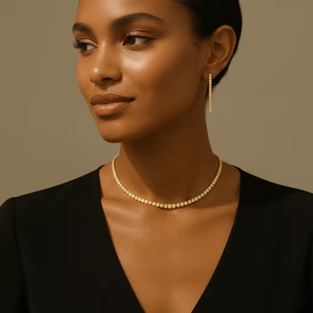 Woman wearing a gold zirconia necklace and matching drop earrings against a beige background