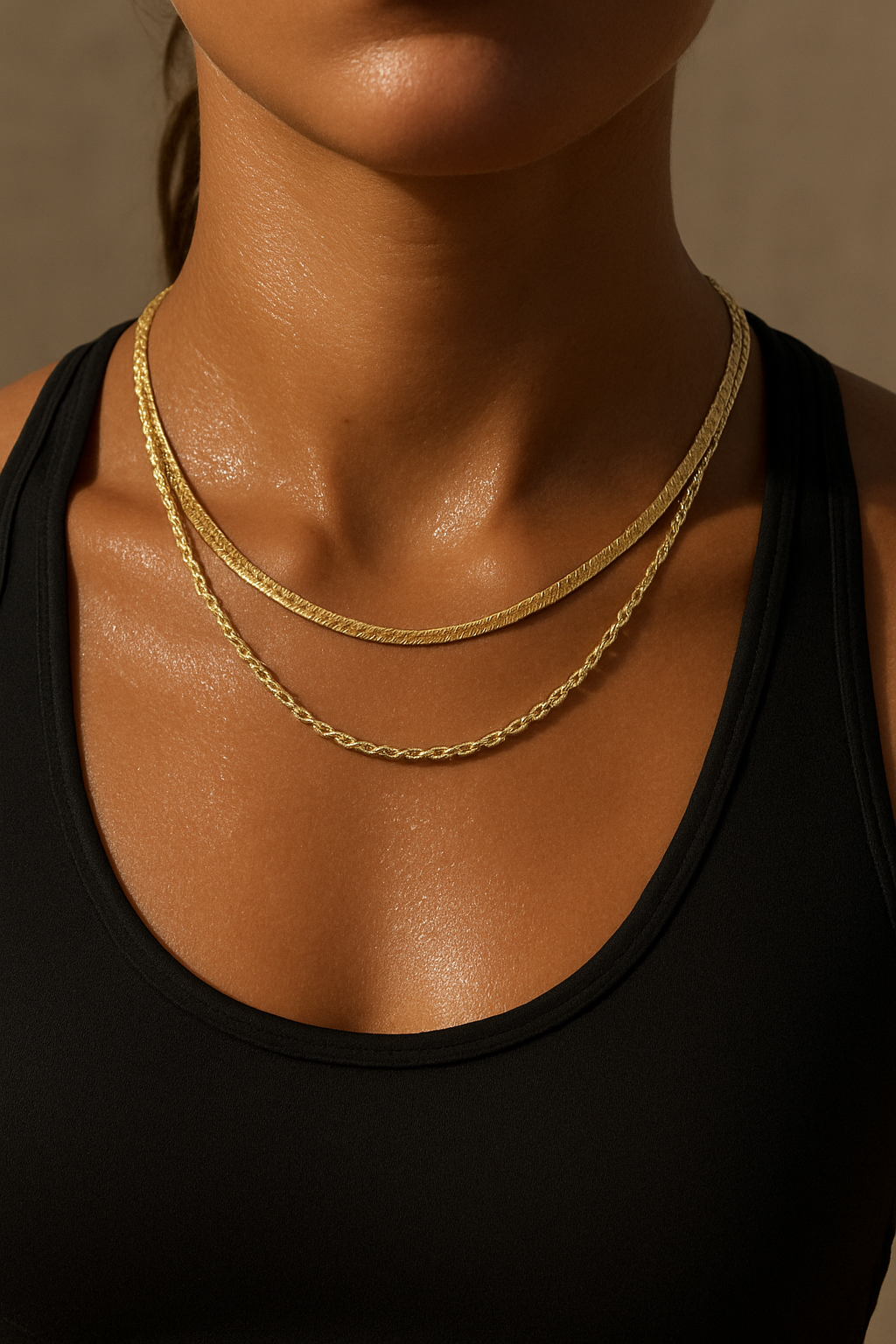 Close-up of a woman wearing two waterproof gold necklaces