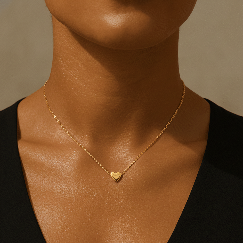 Gold waterproof heart pendant necklace worn by woman