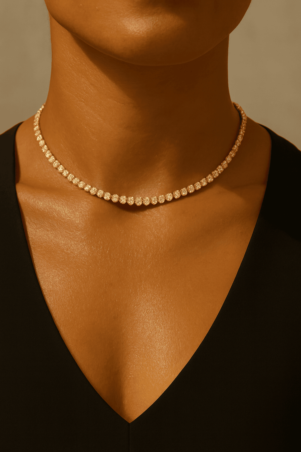 Close-up of a gold diamond waterproof choker on a model 