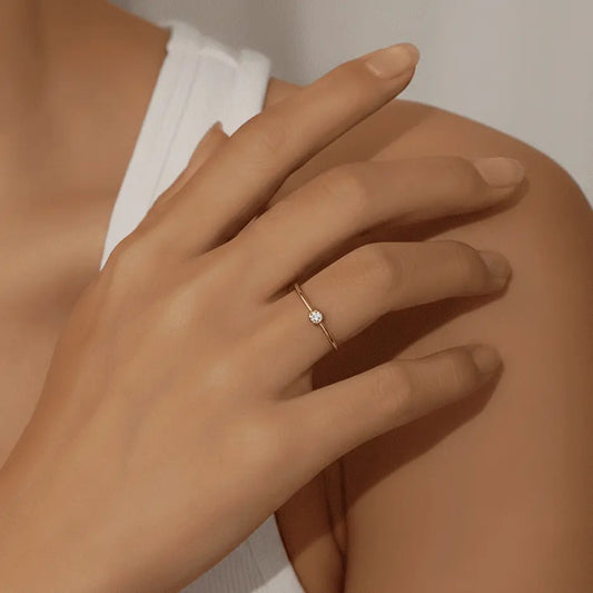 Hand wearing a waterproof gold ring with a diamond