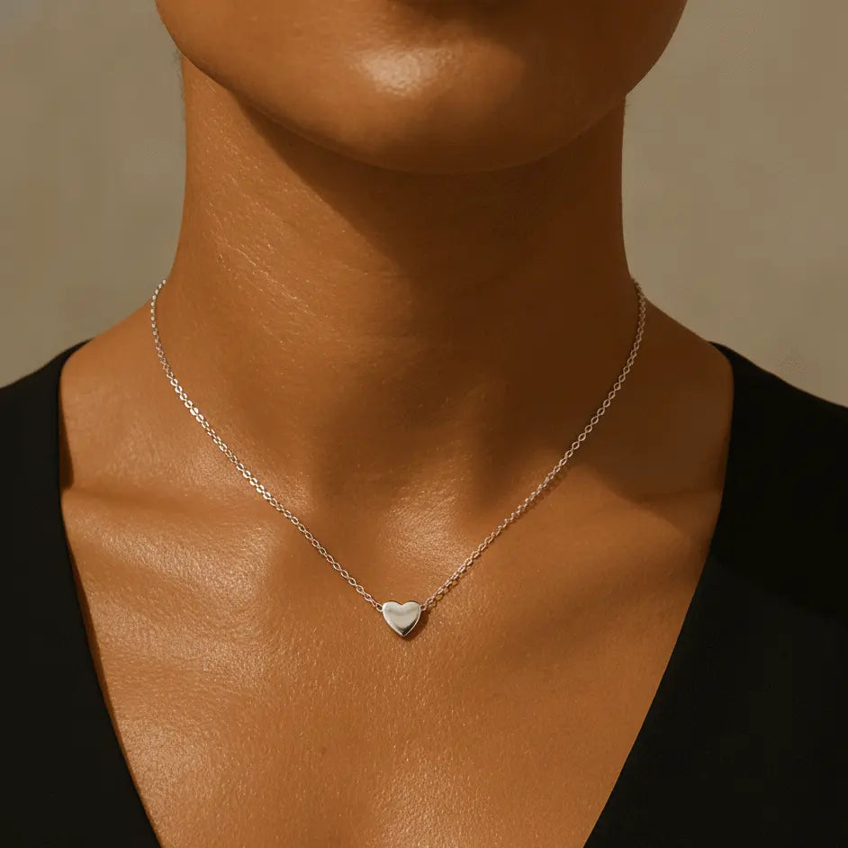 Silver waterproof heart pendant necklace worn by woman